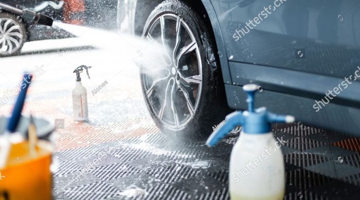 stock-photo-professional-man-washes-car-and-wheels-rims-tires-at-detailing-studio-2546748383