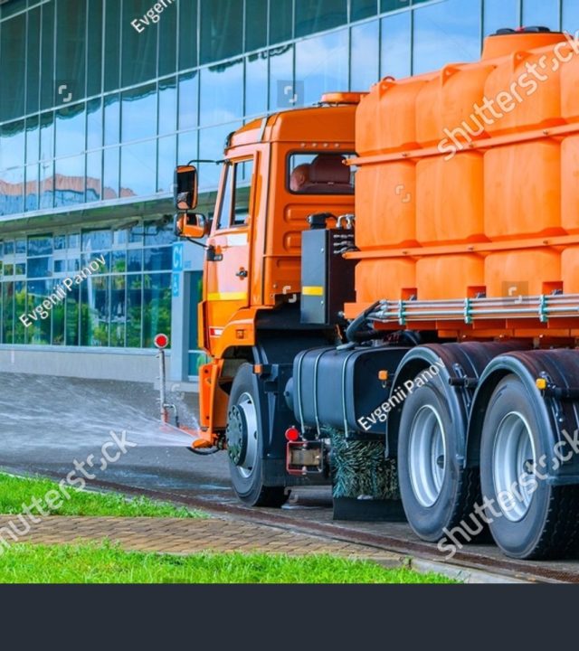 stock-photo-sprinkler-truck-is-wash-the-asphalt-road-by-spraying-water-with-shampoo-on-the-street-municipal-2573678995
