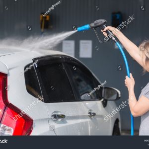 stock-photo-woman-washing-car-in-a-self-service-car-wash-station-2454802869